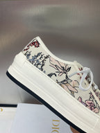 White unisex low-top sneakers with floral-printed canvas and dark trim sole