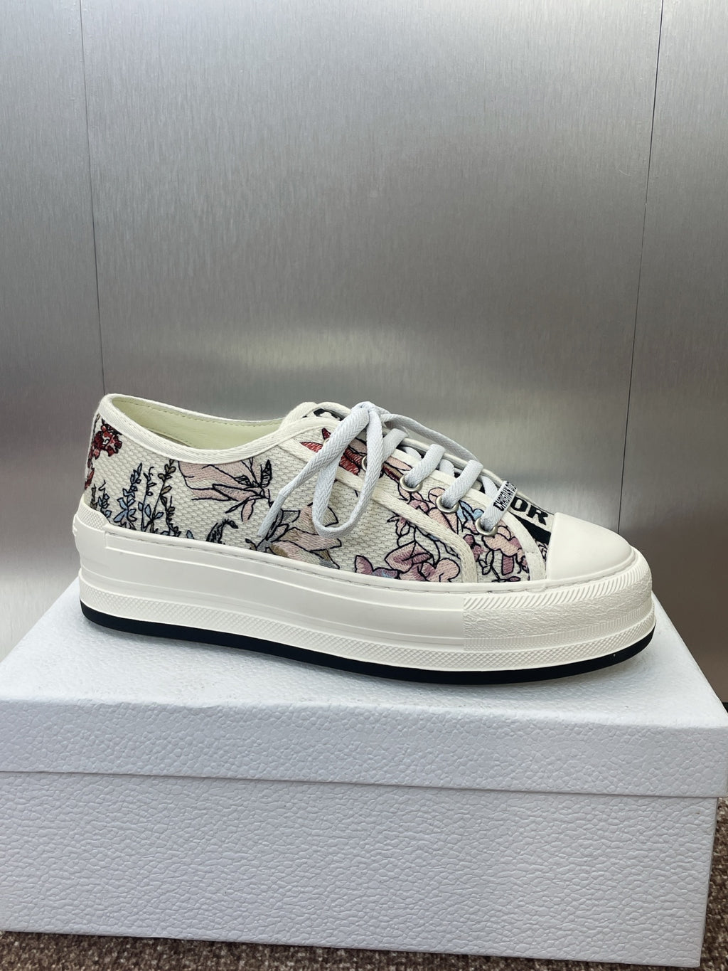 White unisex low-top sneakers with botanical print upper and white lace-up