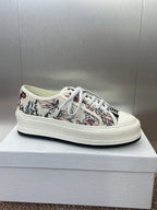 White unisex low-top sneakers with botanical print upper and white lace-up
