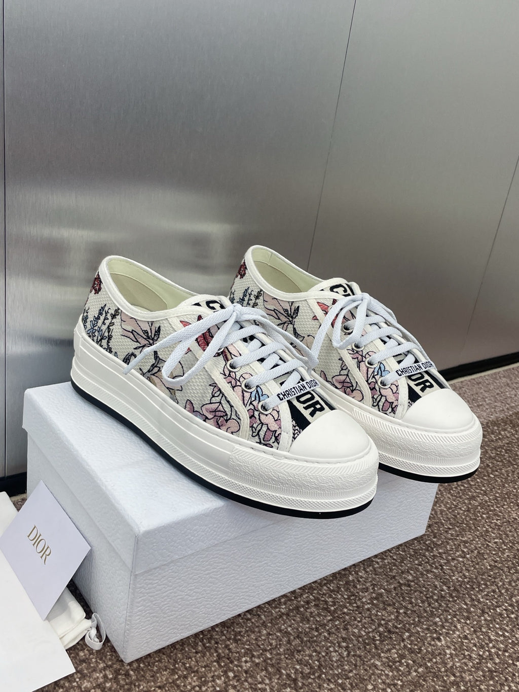 White unisex low-top sneakers with botanical print fabric and lace-up front