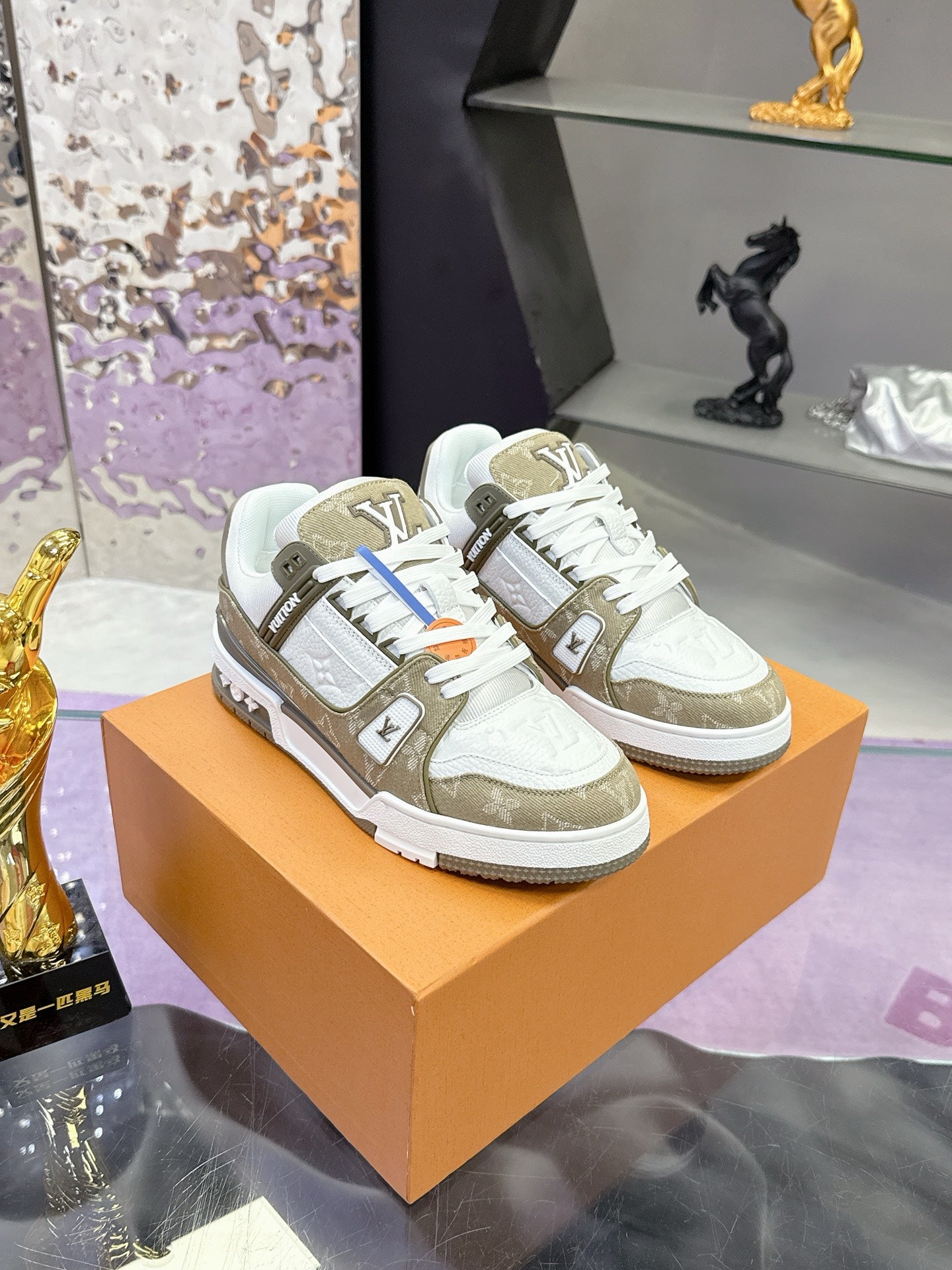 Women’s Louis Vuitton sneakers on box: white uppers with olive side panels and laces