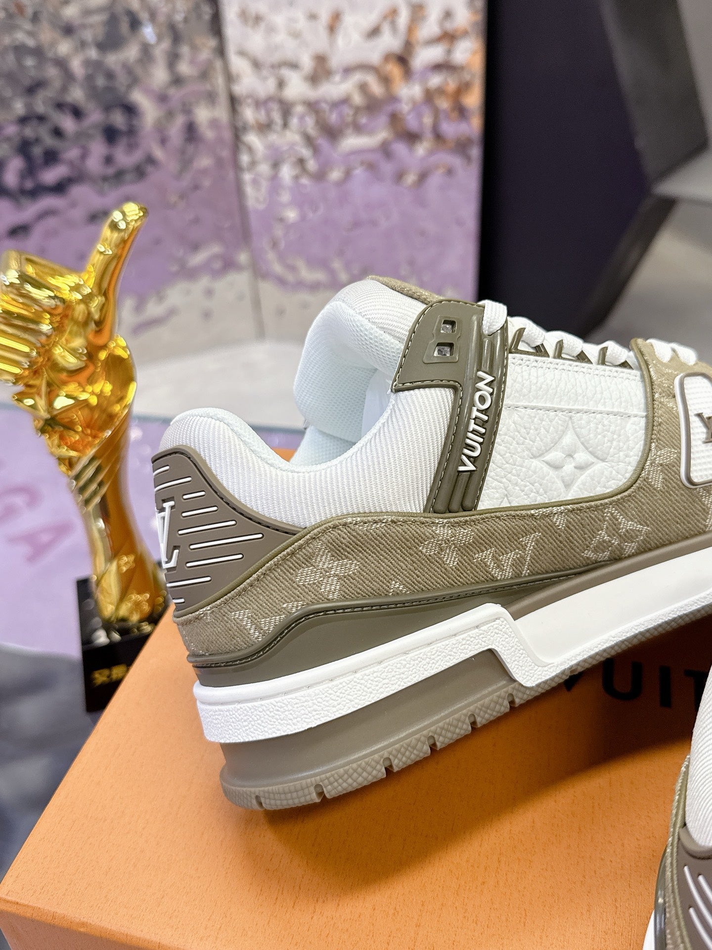 Women’s Louis Vuitton sneakers, side view: white toe with olive overlay and logo tab