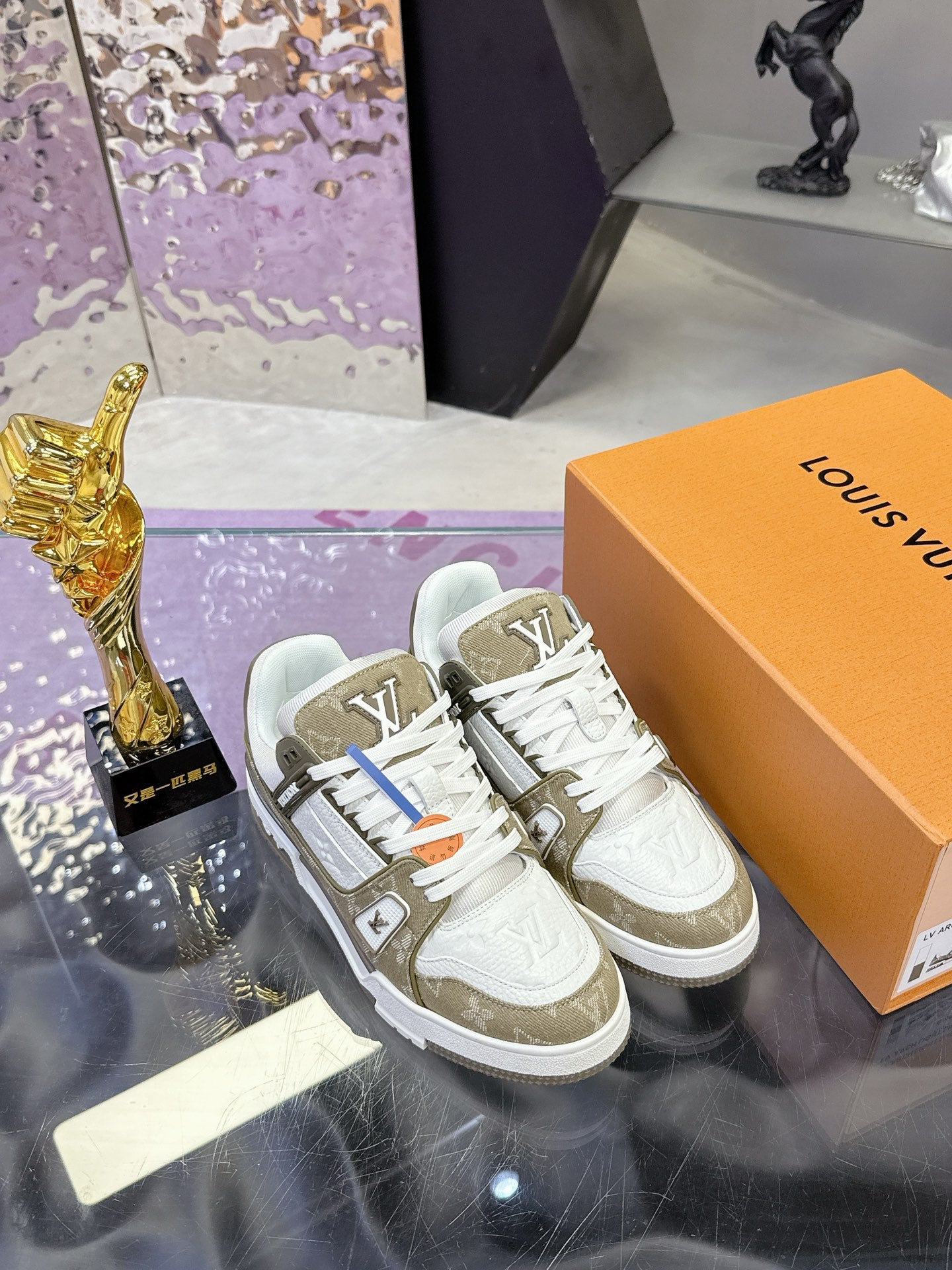 Women’s Louis Vuitton sneakers, paired on box; white uppers with olive logo sides