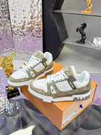 Women’s Louis Vuitton sneakers: white leather with olive overlays, lace-up front view