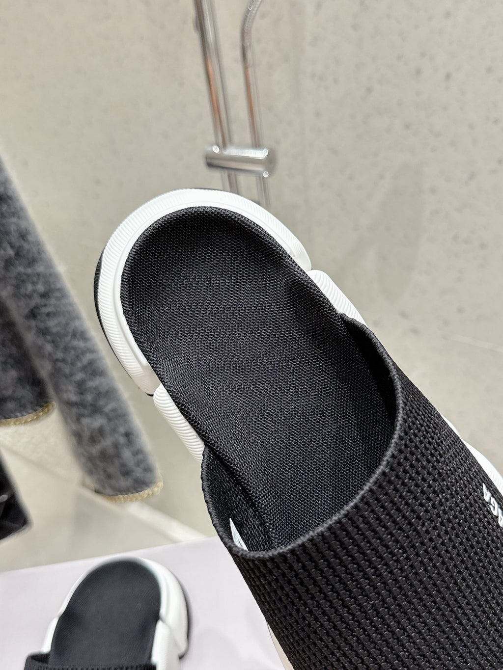 Balenciaga black slide sandal with black insole and white trim, close-up