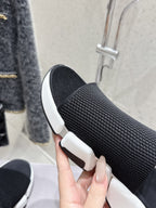 Balenciaga black knit slide sandal showing textured upper and white midsole
