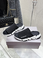 Balenciaga black slide sandals with wide elastic knit straps and white sculpted sole