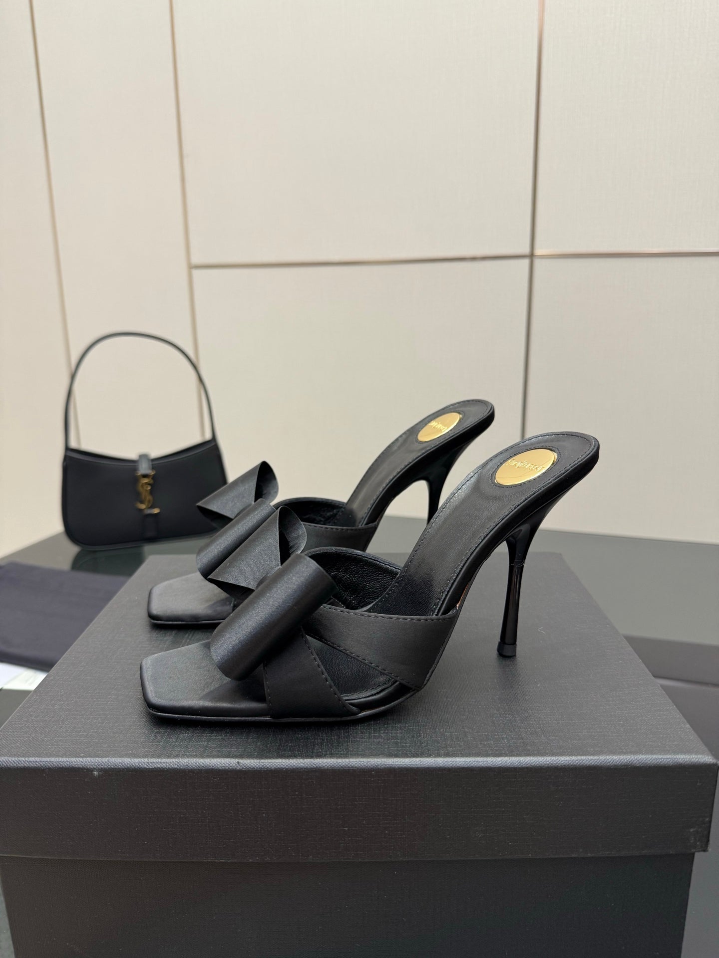 YSL black high-heel mule sandals with bow detail and open sides, pair on box