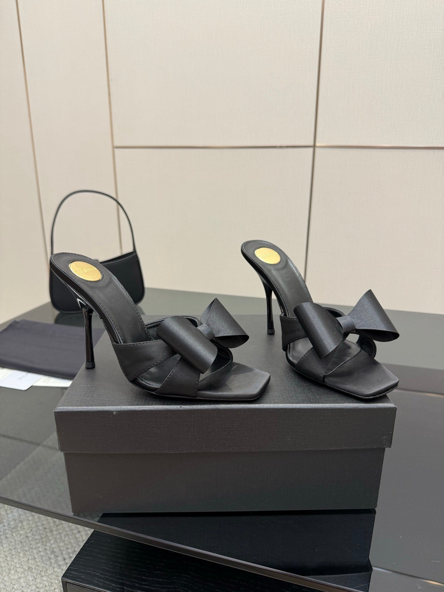 YSL black high-heel mule sandals with wide bow straps, pair on display box