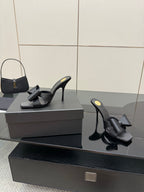 YSL black high-heel mule sandals, one front and one side view on display box