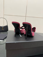 YSL pink satin bow mules, heel view and black insole detail on display box