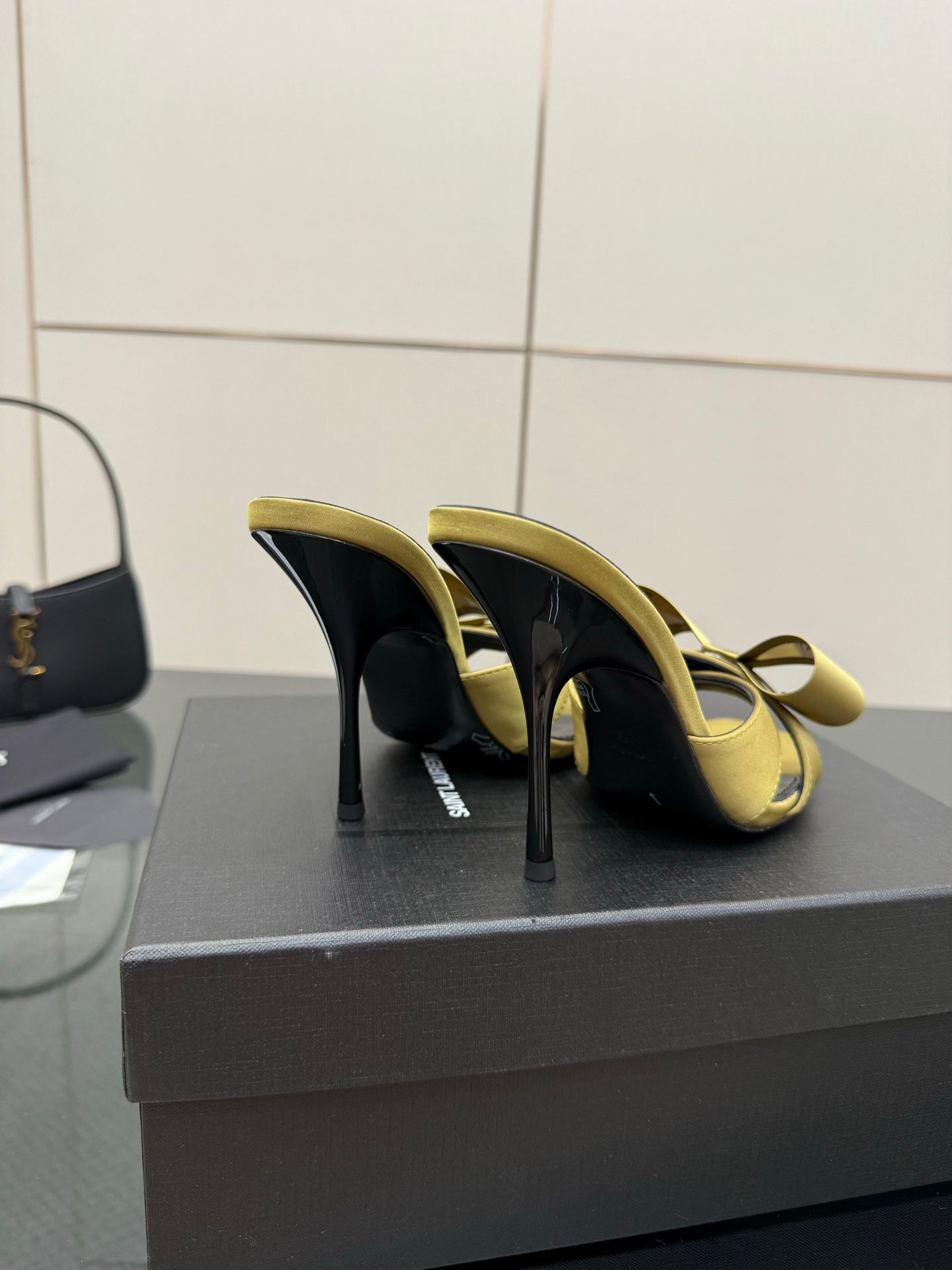 Yellow satin heeled sandals with bow detail and black soles, stiletto heel