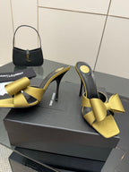 Yellow satin bow mules with black lining and high stiletto heel