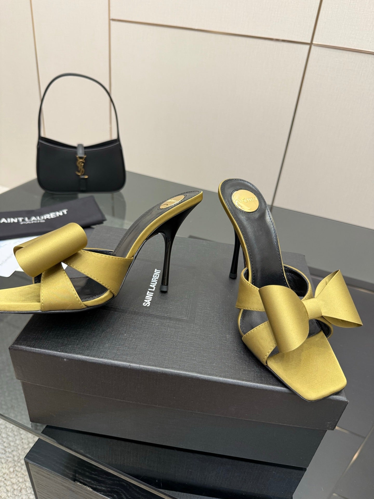 Yellow satin bow mules with black lining and high stiletto heel