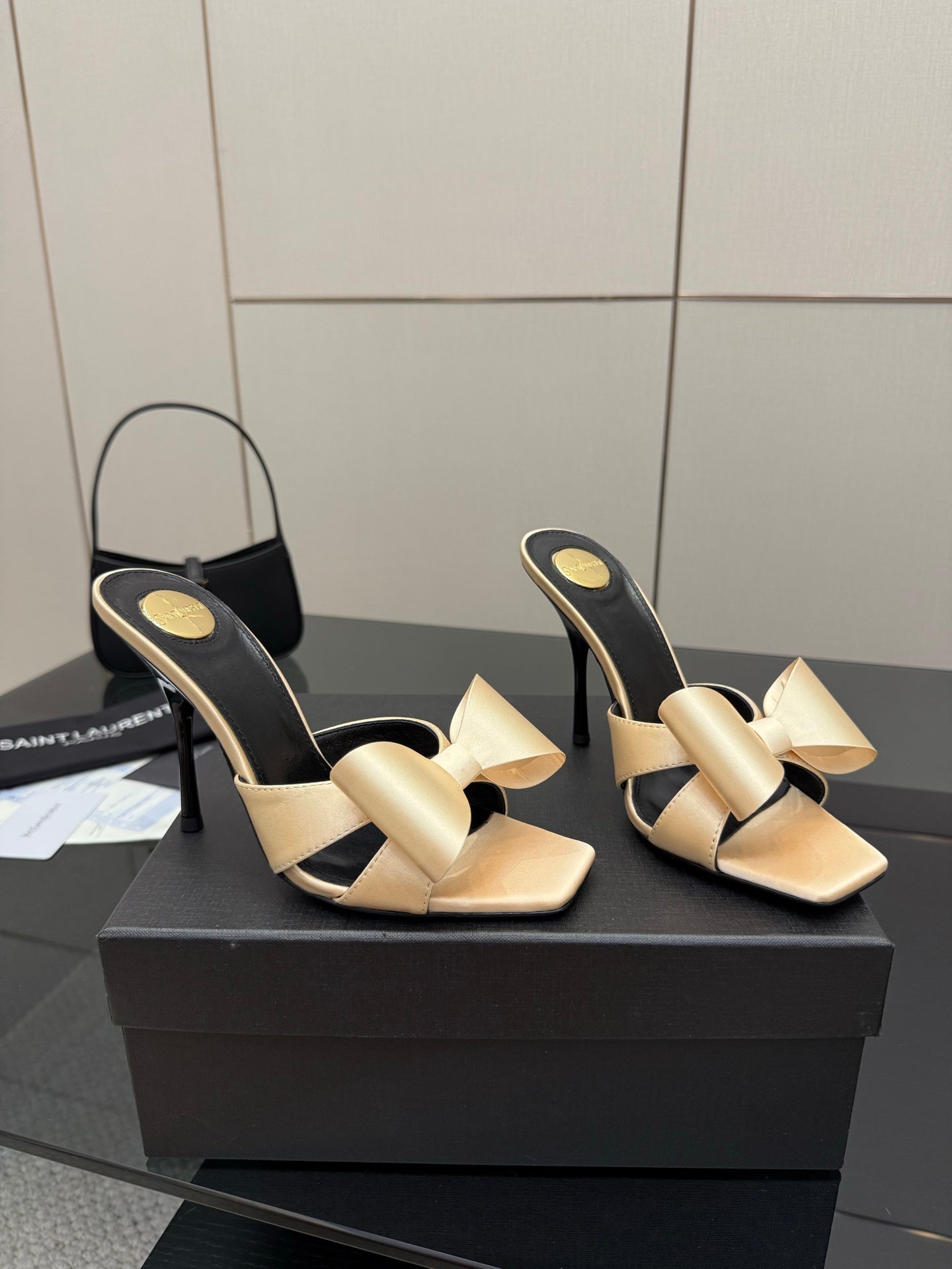 Two-tone heeled mules with black lining and beige bows, high stiletto heel
