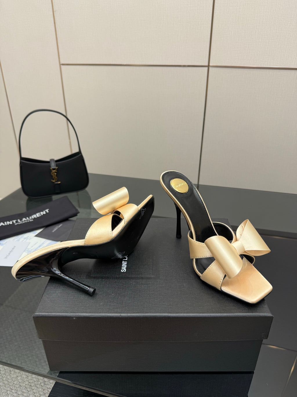 Pair of two-tone heeled mules, beige bow straps and black curved high heel