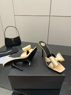 Pair of two-tone heeled mules, beige bow straps and black curved high heel