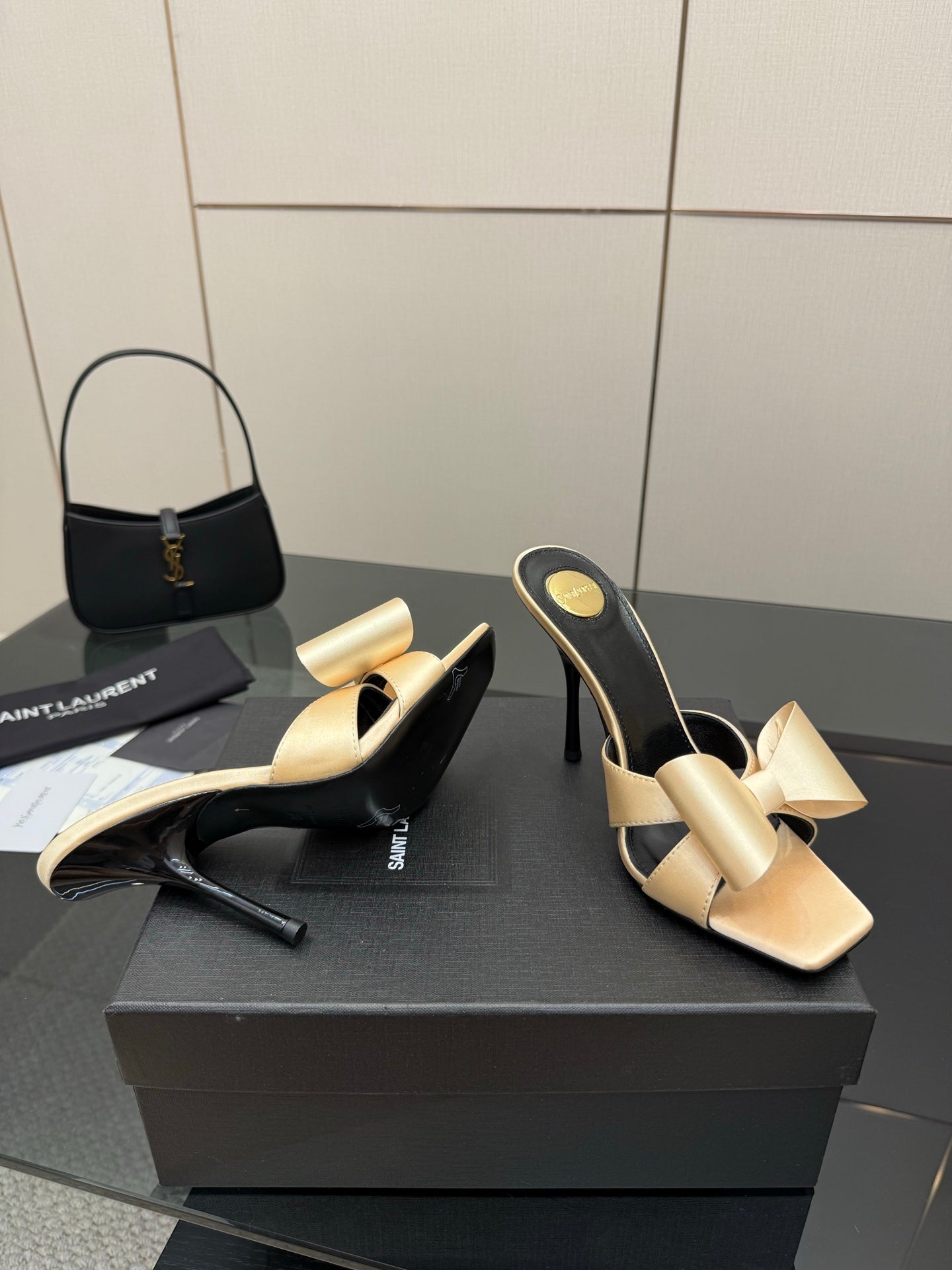 Pair of two-tone heeled mules, beige bow straps and black curved high heel