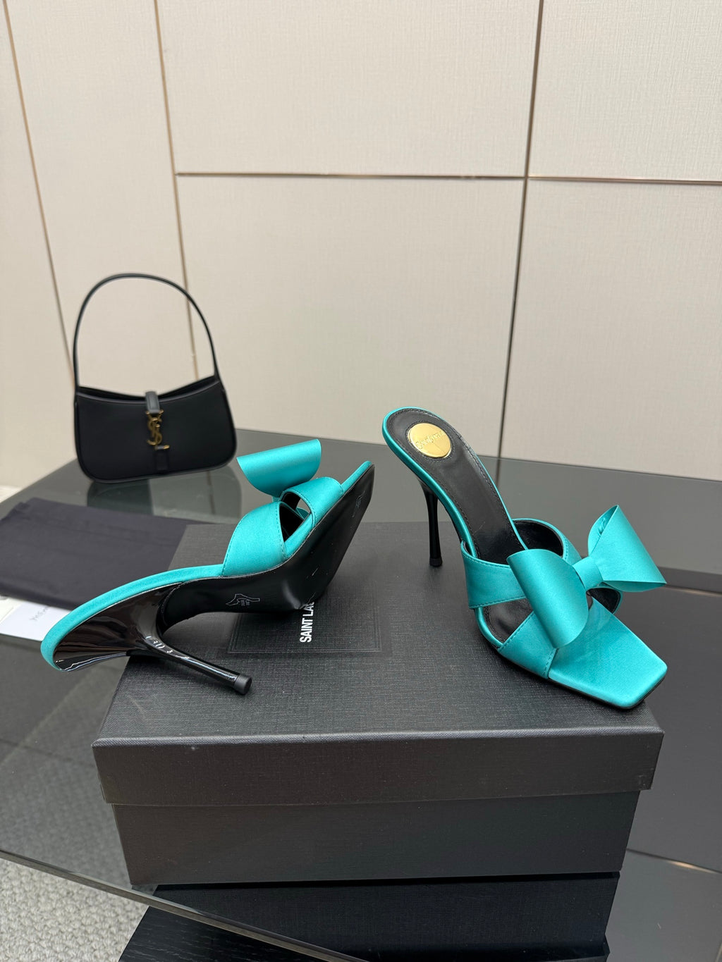 Turquoise bow mule heels, side profile with slender stiletto heel, black interior