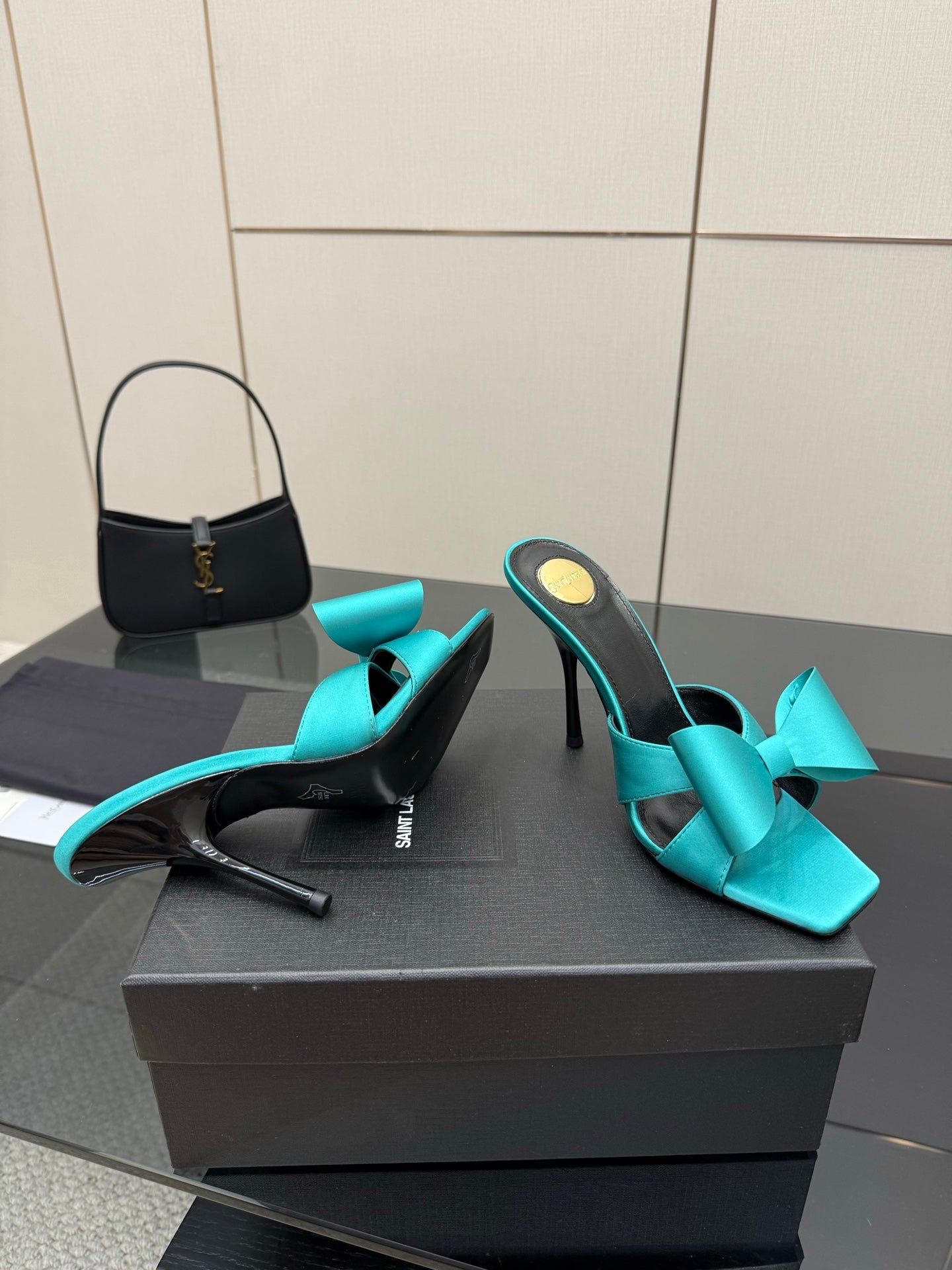 Turquoise bow mule heels, side profile with slender stiletto heel, black interior