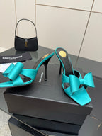 Turquoise bow mule heels with stiletto heel, open toe, black insole and lining