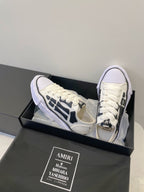 Amiri white and black lace-up sneakers, angled side view