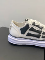 Amiri white and black lace-up sneakers, side profile close-up