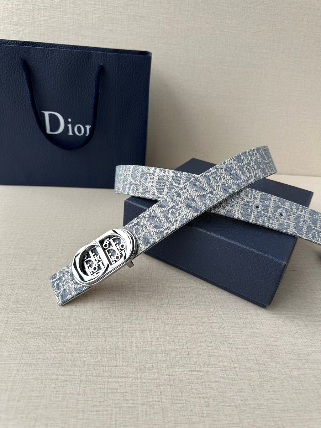 Dior belt folded with blue-and-white monogram webbing and silver buckle