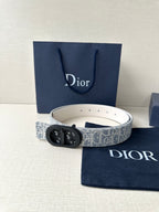 Dior belt with light patterned strap and black oval logo buckle