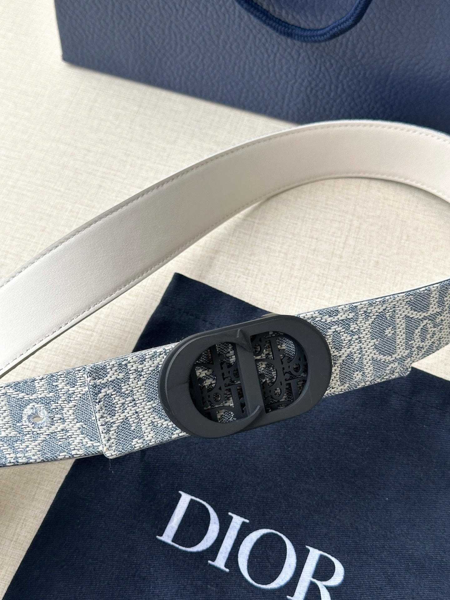 Dior belt buckle detail on patterned fabric strap