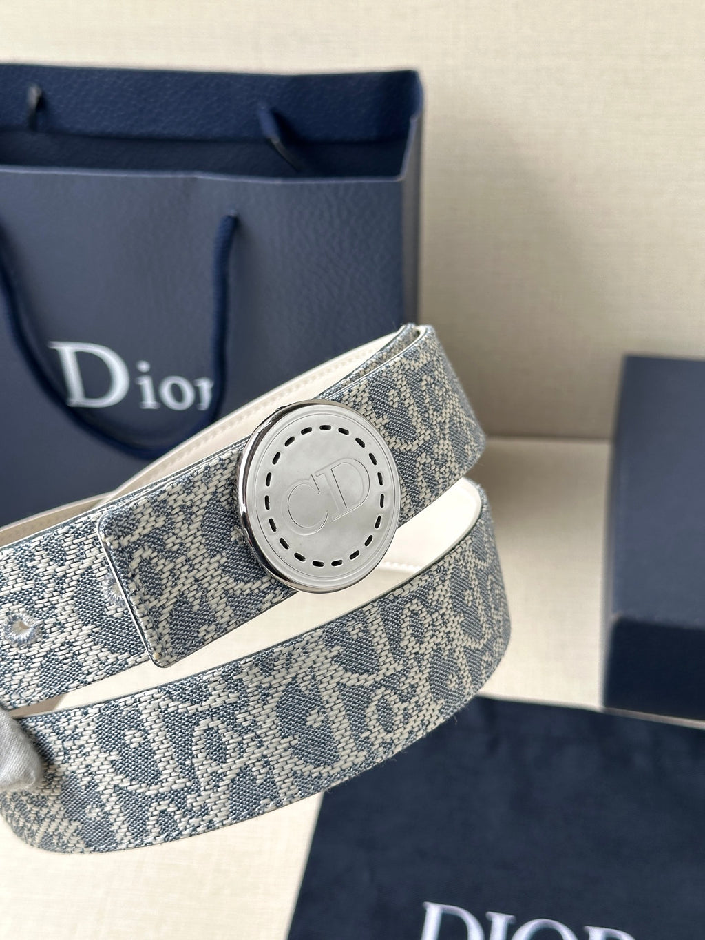 Dior monogram belt with round pale buckle on blue patterned strap