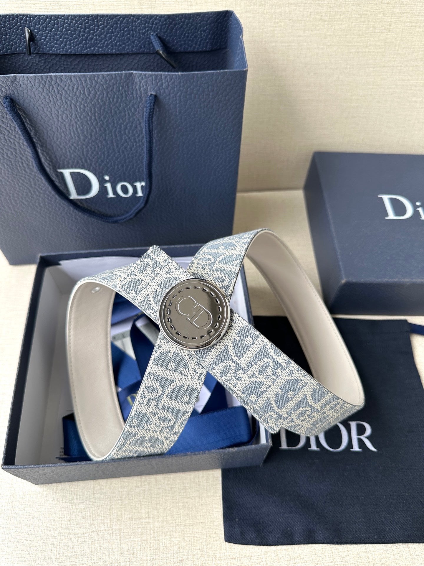 Dior monogram belt with round buckle and blue patterned strap, logo plate