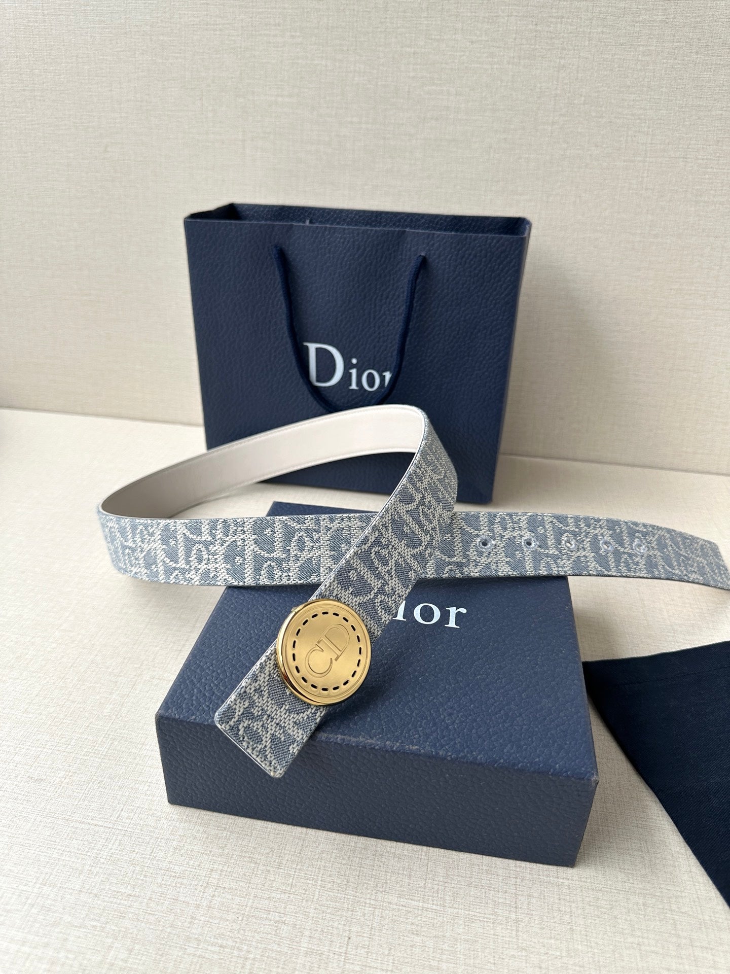 Dior monogram belt with round gold buckle on blue patterned strap