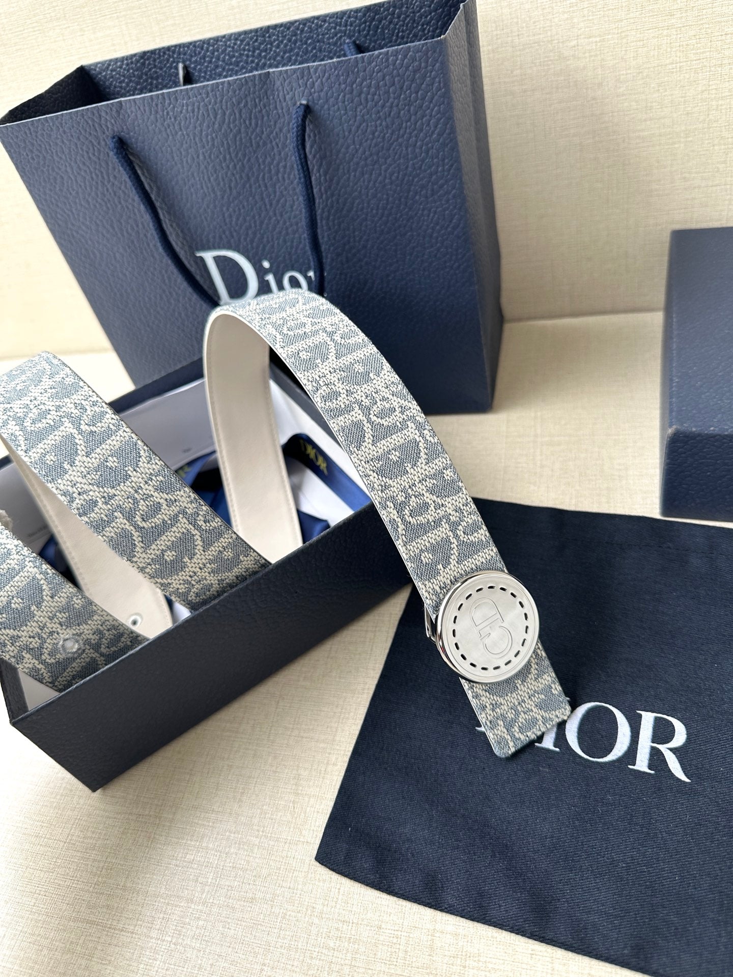 Dior monogram belt with round pale buckle on blue patterned strap