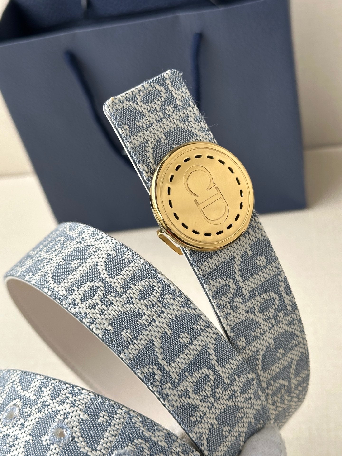 Dior monogram belt with two-tone blue patterned strap and round gold buckle