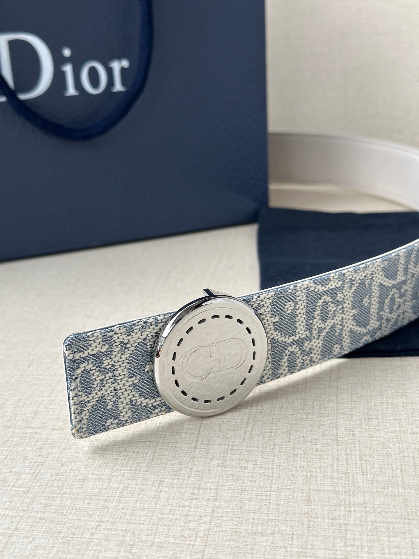 Dior monogram belt with round pale buckle on blue patterned strap