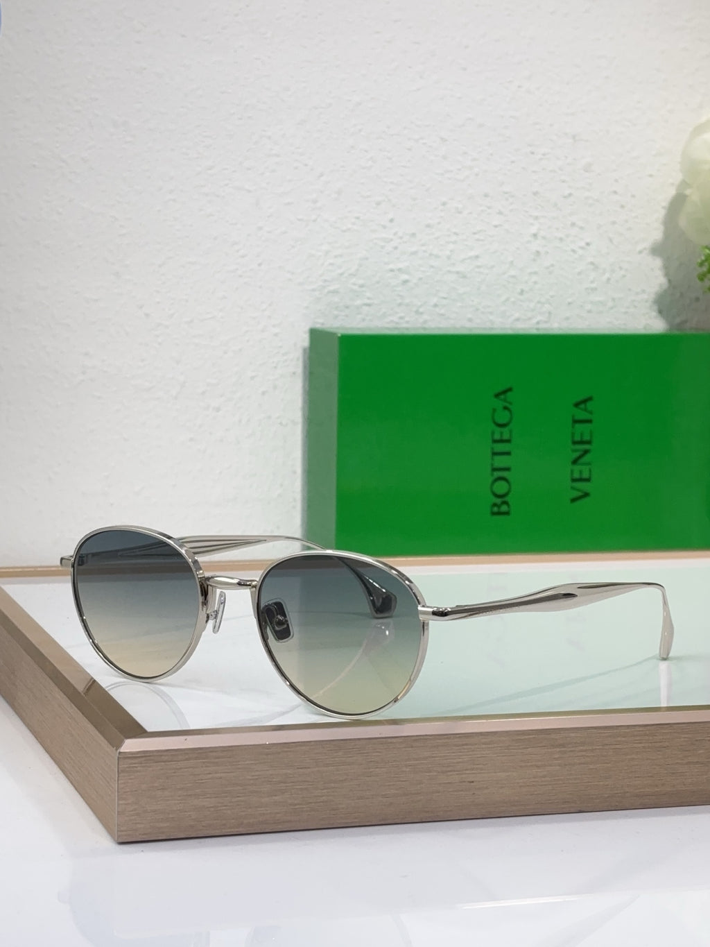 Bottega Veneta round sunglasses with gold-tone metal frame and blue-gray tinted lenses
