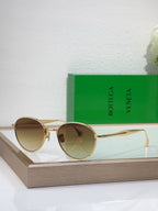 Bottega Veneta round sunglasses with gold-tone metal frame and light amber tinted lenses