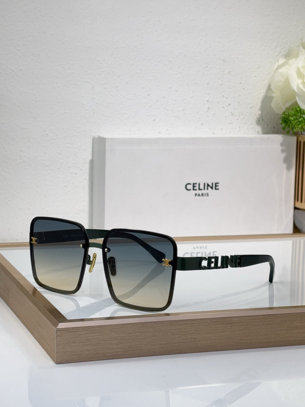 Sunglasses with black square frame, dark lenses, gold decorative temple hardware