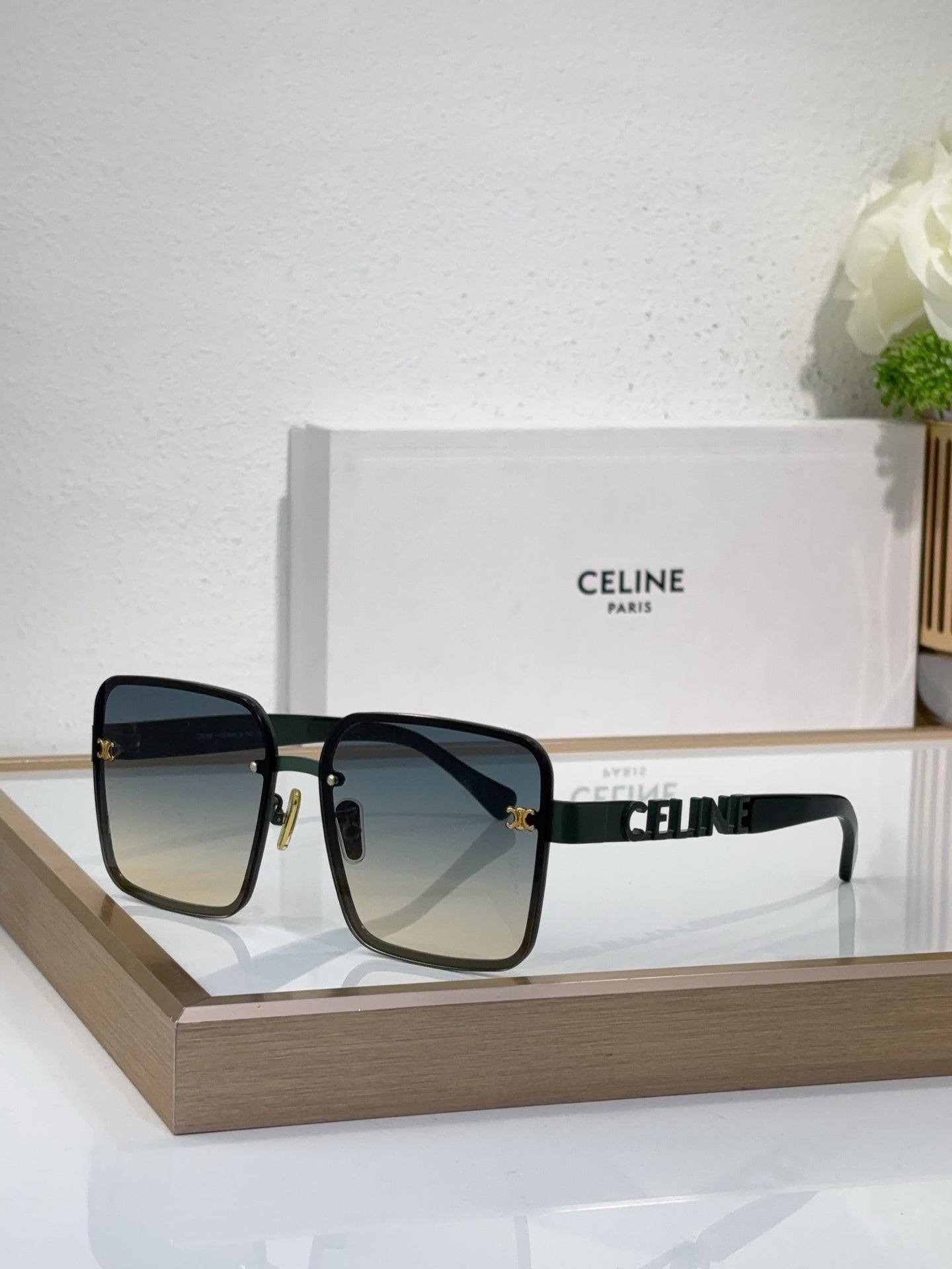 Sunglasses with black square frame, dark lenses, gold decorative temple hardware