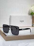 Sunglasses with black oversized square frames and dark tinted lenses, gold hardware