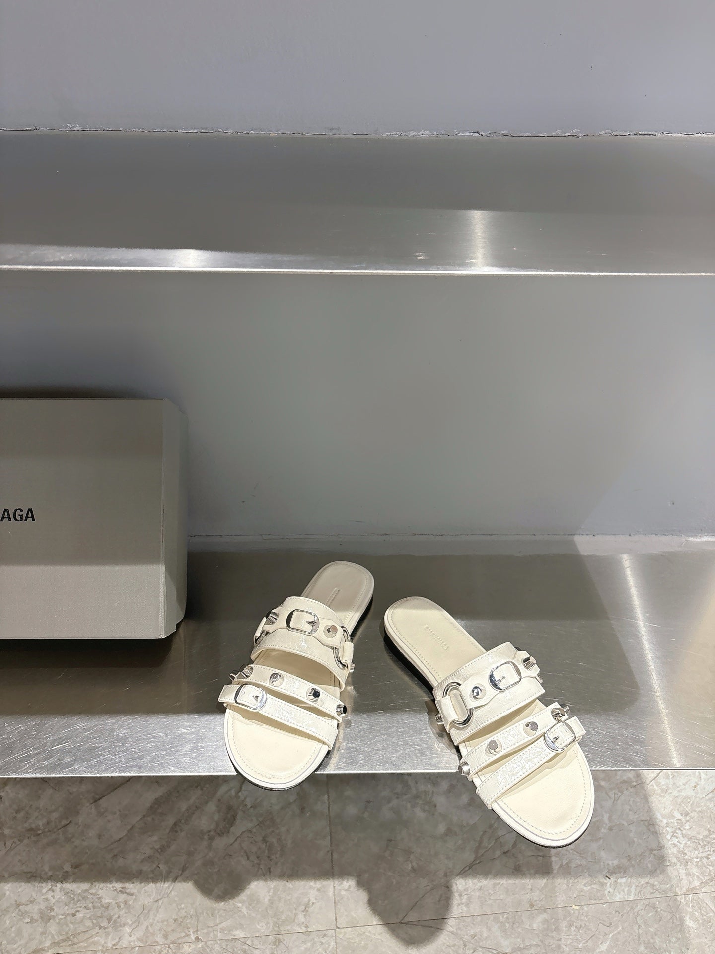 Balenciaga leather slide sandals in white with three adjustable buckle straps.