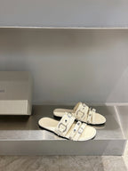 Balenciaga leather sandals in white with multiple buckle straps on flat slide sole.