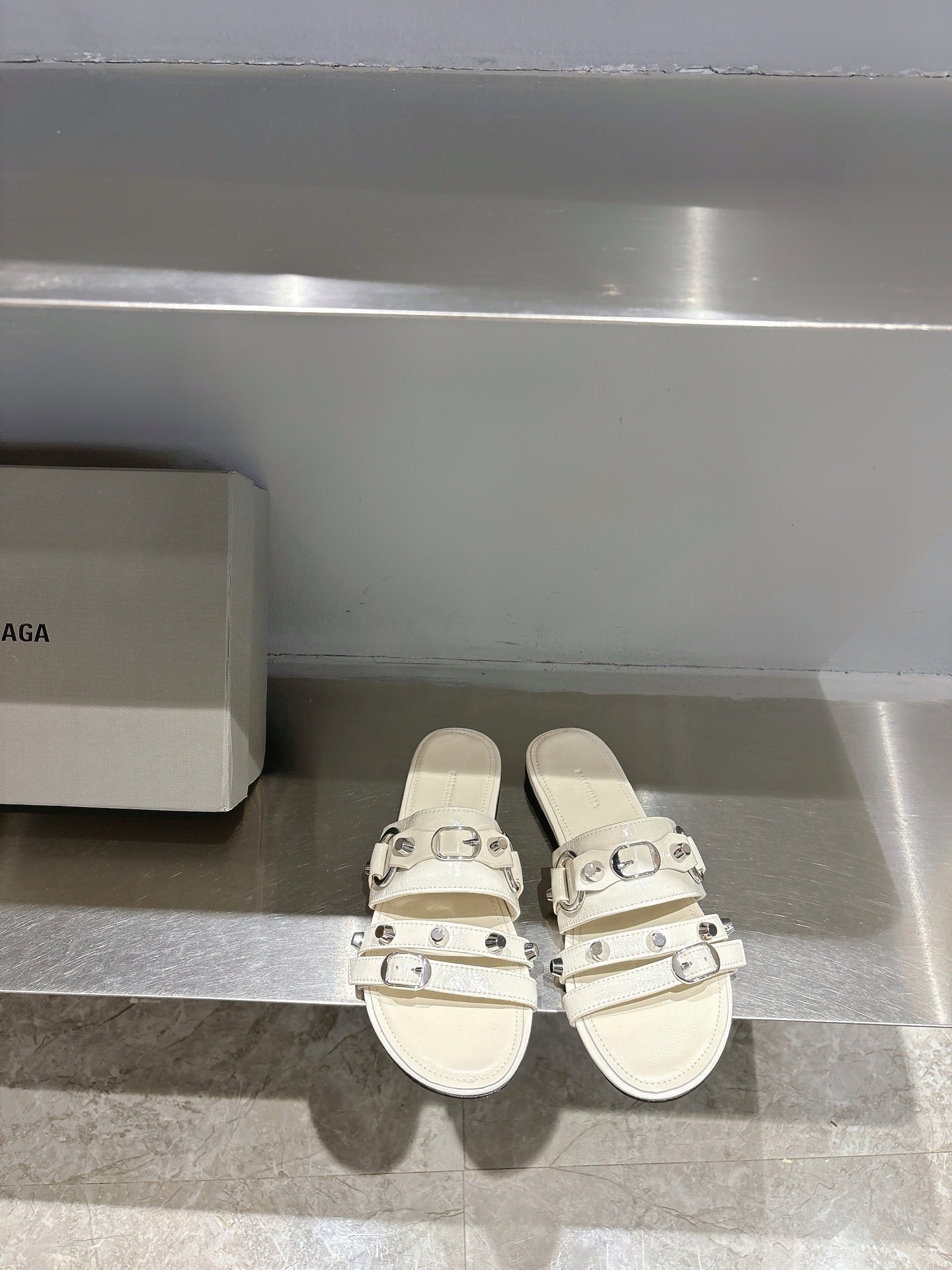 Balenciaga leather sandals in white with three buckle straps, open toe.