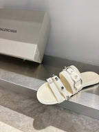 Balenciaga leather slide sandals in white with multiple buckles and sculpted straps.