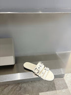 Balenciaga leather slide sandal in white with side buckle detail and flat footbed.