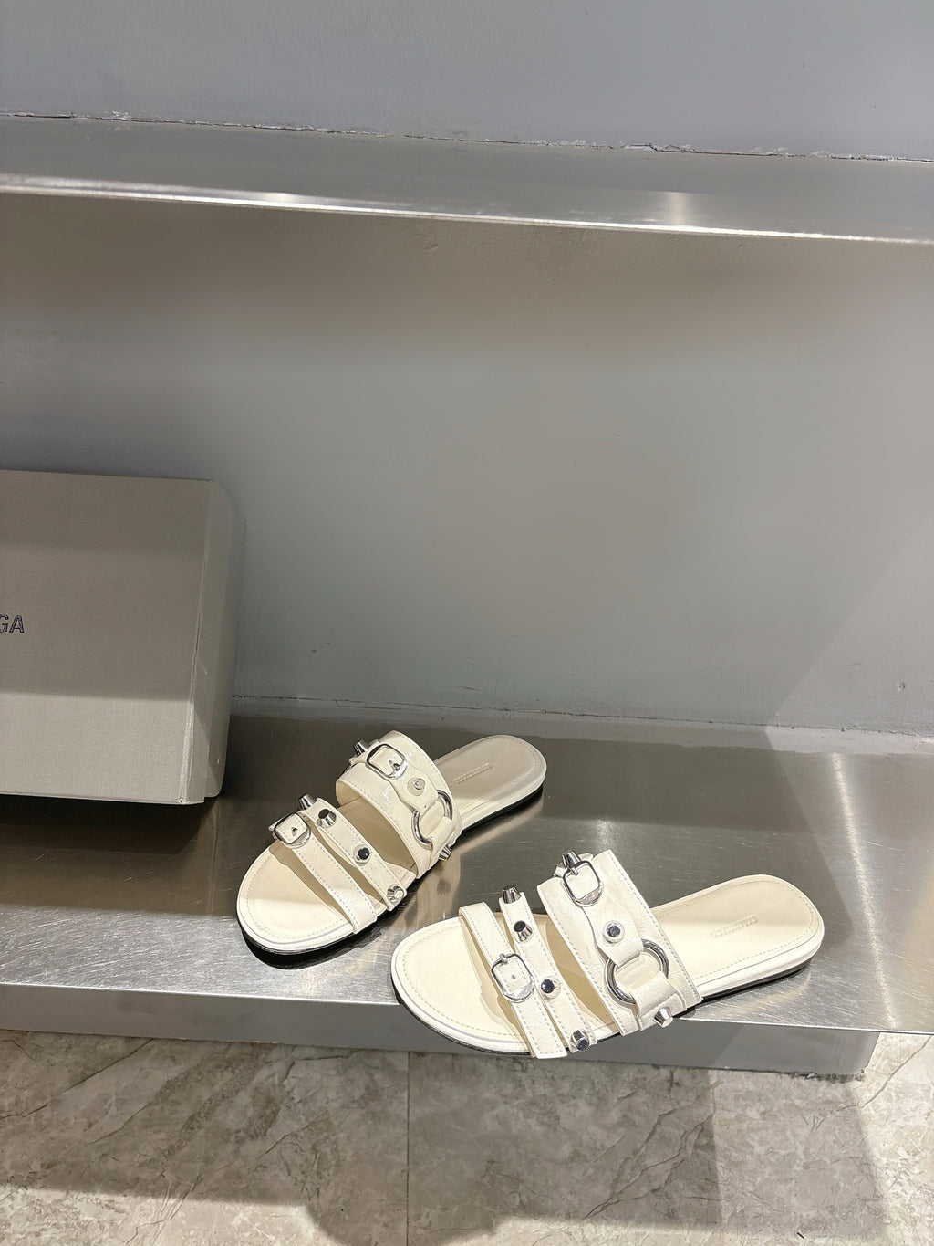 Balenciaga leather sandals in white with three-buckle upper and flat sole.