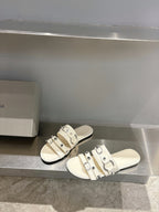 Balenciaga leather sandals in white with three-buckle upper and flat sole.