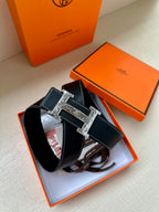 Dark blue leather belt with silver buckle, displayed with orange boxes