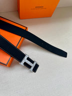 Dark blue leather belt with silver buckle and stitched edge details